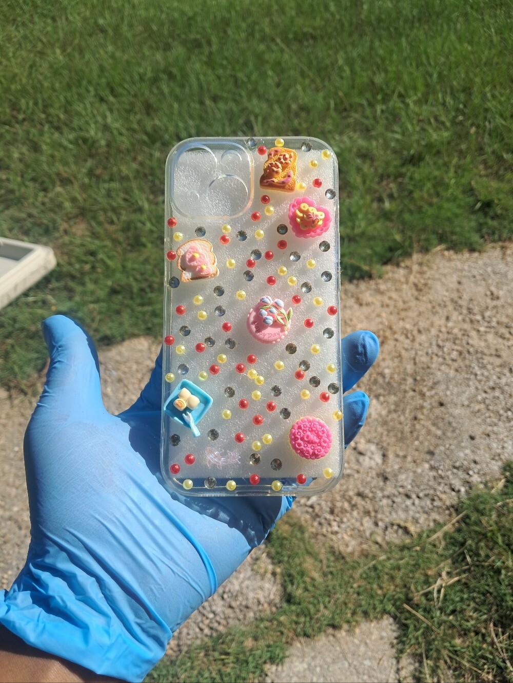 iPhone 15. Clear Decorative Phone Case with Pink & Multicolor Accents
